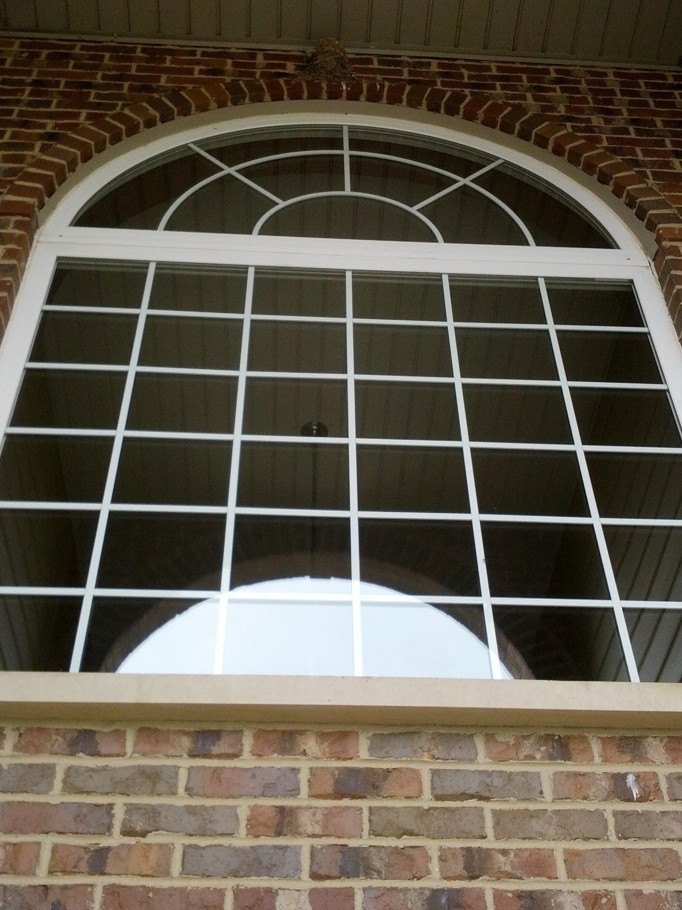 Clean arched foyer window after professional cleaning